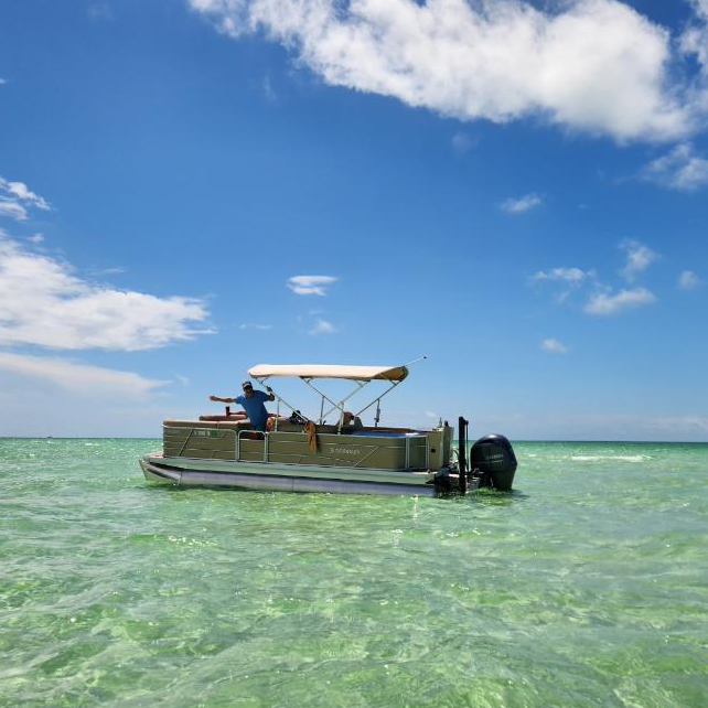 Shawn boating on turquoise water